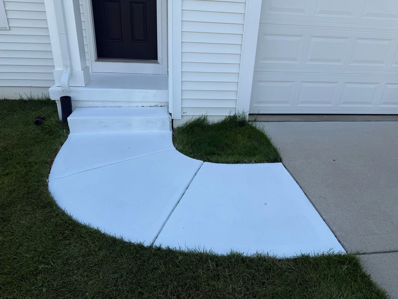 Matching entry steps and curved walkway with a fresh uniform white finish