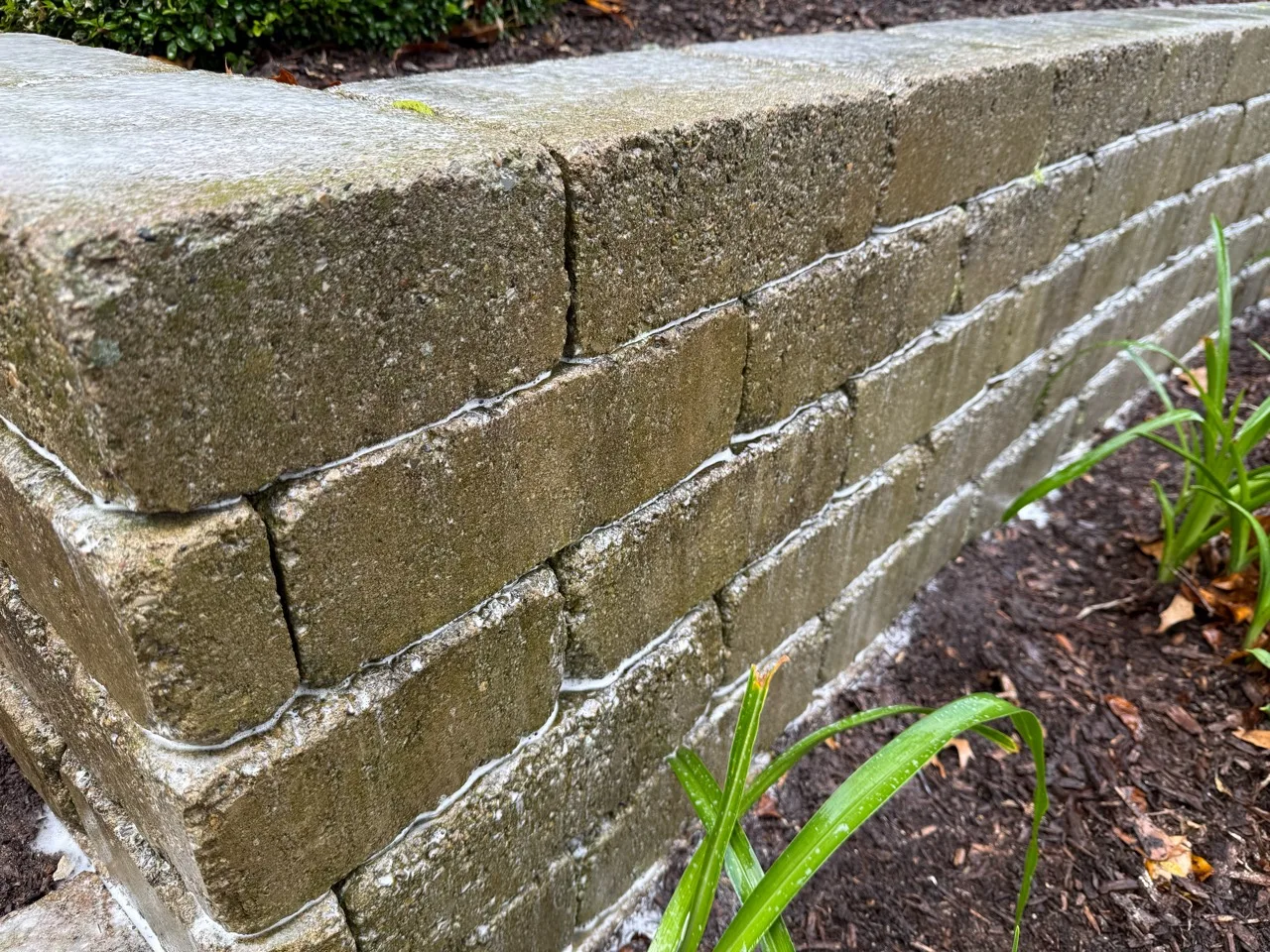 Close-up of a block retaining wall during cleaning