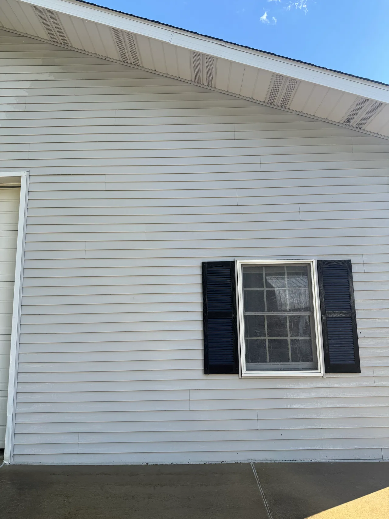 Matching gabled vinyl siding with the visible surface buildup removed