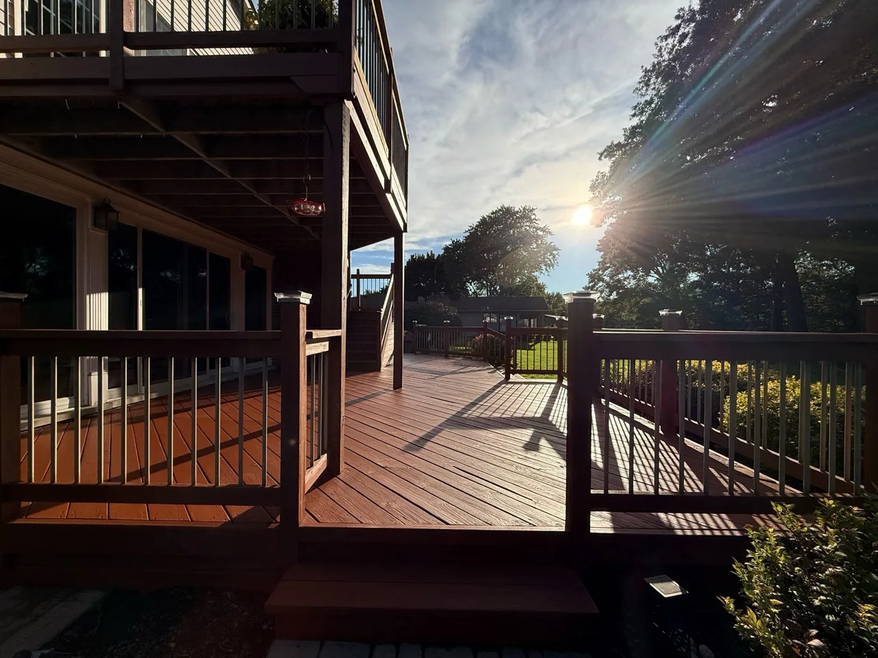 Warm brown two-level wood deck in late afternoon light