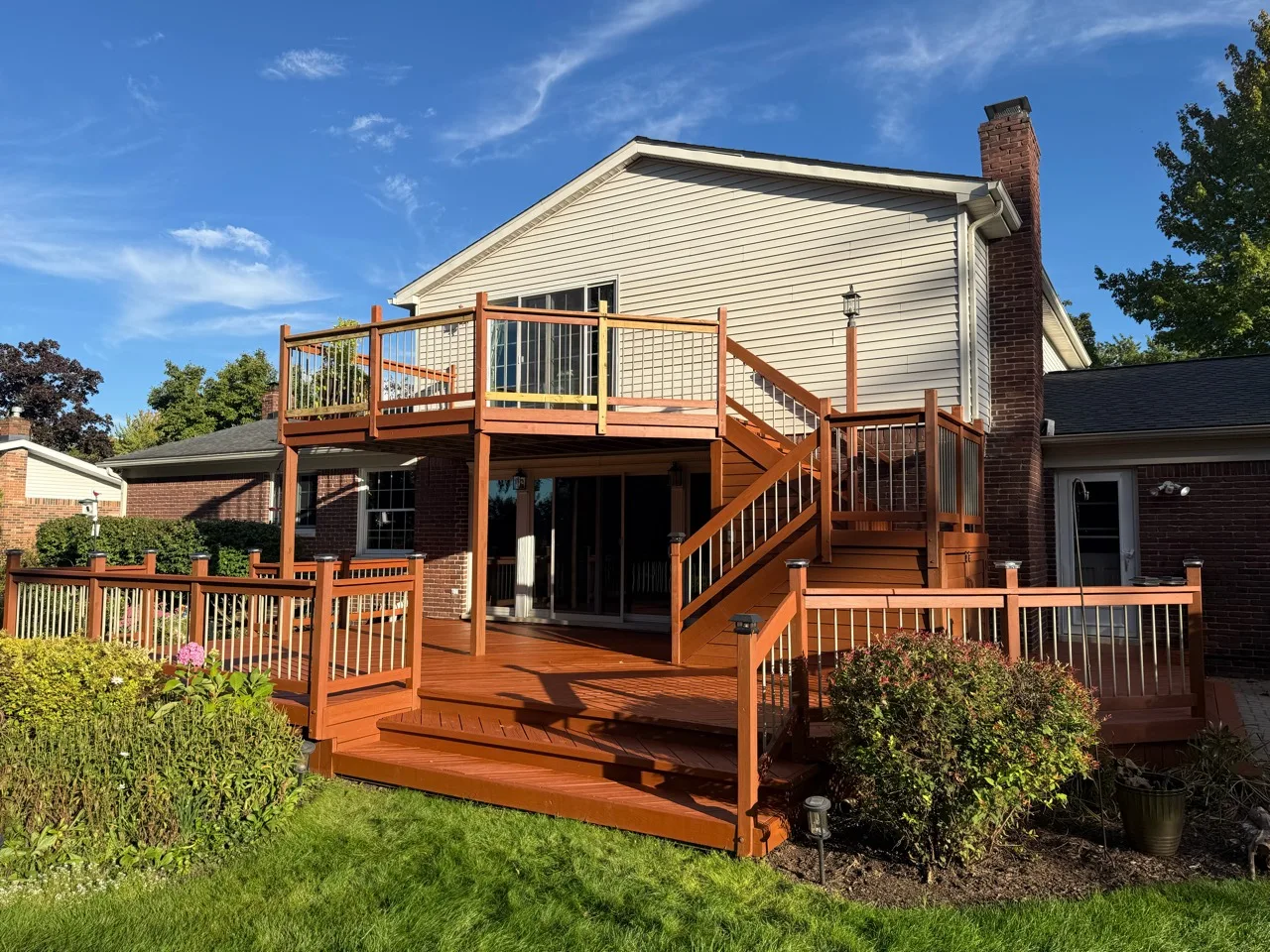 Wide view of a two-level deck and stairs with warm orange-brown wood tones